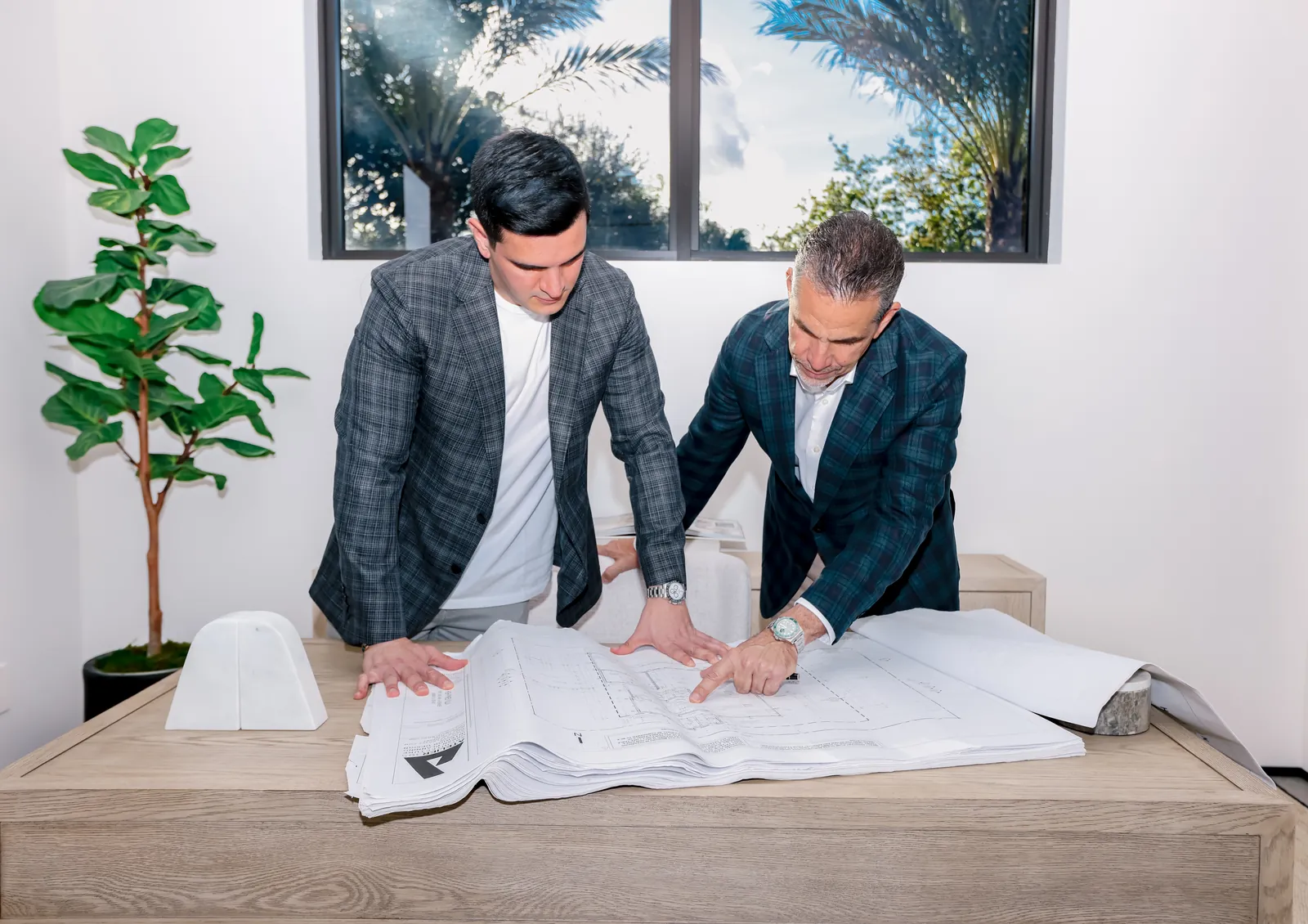 Luis Rodriguez Sr. and Luis Rodriguez Jr. reviewing plans
